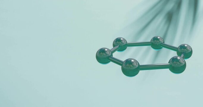 Animation of molecule model spinning over leaf shadow on green background