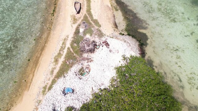 Aerial bird view tilt up fishermen walk fishing village, Fernado island los Roques