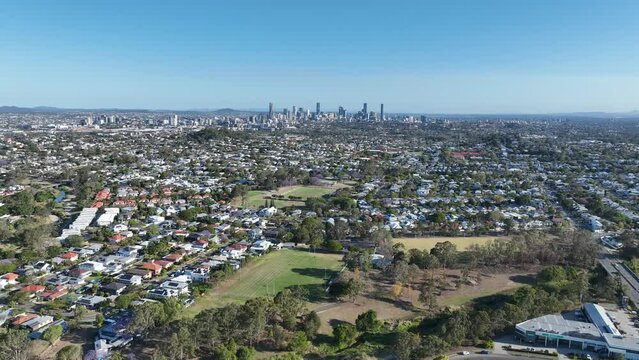 Establishing drone shot of Brisbane City, Grange and Lutwyche. Shot from above Grange Forest Park, Sideways tracking shot facing towards Brisbane CBD. Brisbane Queensland Tourism.