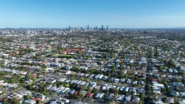 Establishing drone shot of Brisbane City, Grange and Lutwyche. Shot from above Grange Forest Park, Push in flying towards city. Brisbane Queensland Tourism.