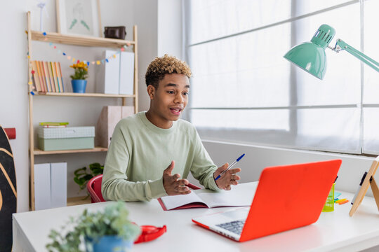 Young african american teen boy student having a video call using laptop at home. Education lifestyle