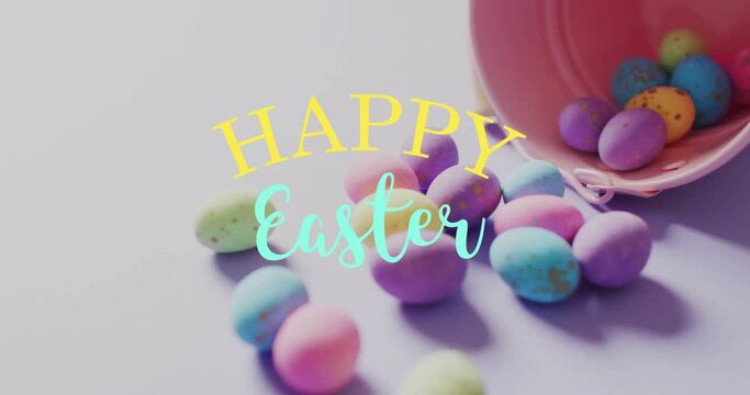 Animation of happy easter text over colourful easter eggs and pink bucket on purple background