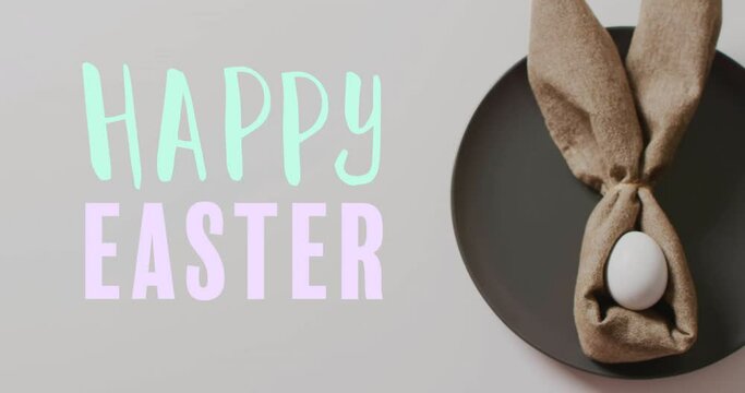 Animation of happy easter text over easter eggs in cloth on white background