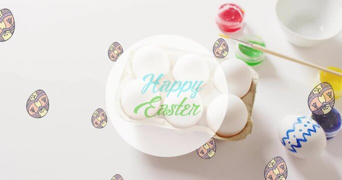 Animation of happy easter text over eggs and paints on white background