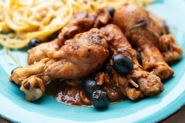 Chicken cacciatore with black olives, pepperoni, tomatoes, with italian spaghetti pasta. Italian food