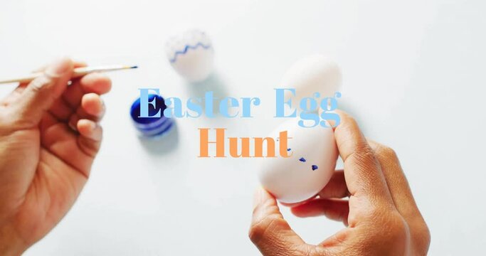 Animation of easter egg hunt text over biracial woman painting easter eggs on white background