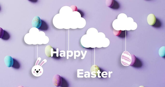 Animation of happy easter text over clouds with colourful easter eggs on purple background