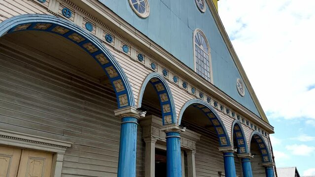 Panning Up View Of Blue And Yellow Church Of Our Lady Of The Rosary, Chonchi Chile Island