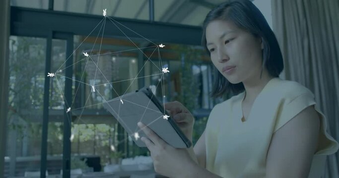 Animation of currency signs, network and data processing over asian woman using tablet