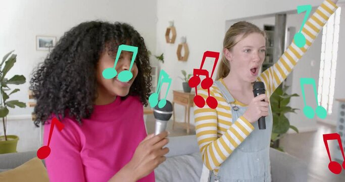 Animation of musical notes over happy diverse teenage girls singing karaoke at home