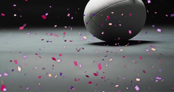 Animation of confetti over white rugby ball on black background