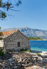 Abandoned old stone house on rocky coast at Vrnik island near Korcula, Croatia