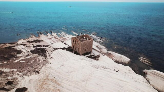 An abandoned stone house close to Agrigento inside the natural reserve of Punta Bianca along the white cliffs Coast in Sicily, Italy.
