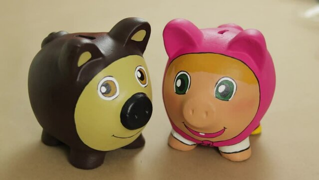 Piggy banks designed with inspiration from characters of Masha and the Bear