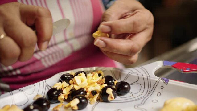 Closeup shot of a Jamaican woman cleaning traditional Ackee fruit used for the national dishes.