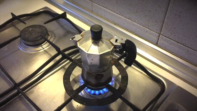 Closing Lid on Moka Pot Over Fire on stovetop