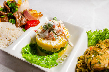 Ceviche, chicken with rice, and lomo saltado. Peruvian gastronomy. Copyspace
