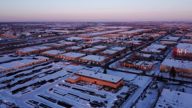 Industrial area covered in snow during sunset