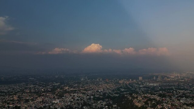 Aerial view of the cityscape of Indore with a cloudy dusk sky in the background at sunset, India