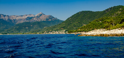 Picturesque lake with distant mountains in Thassos, Greece