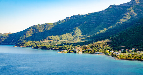 Obraz premium Scenic landscape with boats on the water in Thassos, Greece