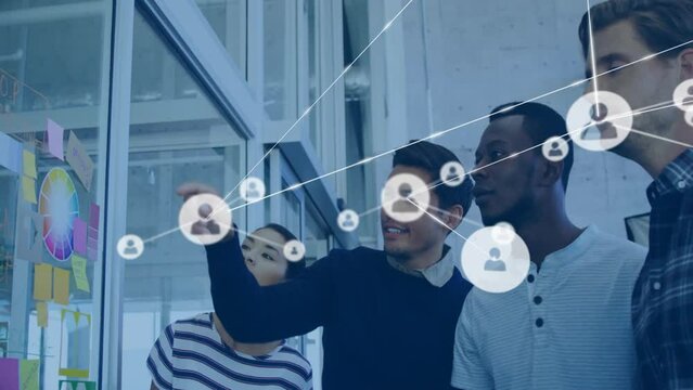 Animation of network of connections with people icons over diverse business people in office