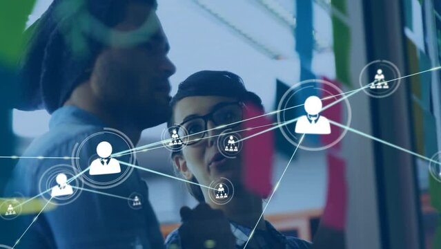Animation of network of connections with people icons over diverse business people in office