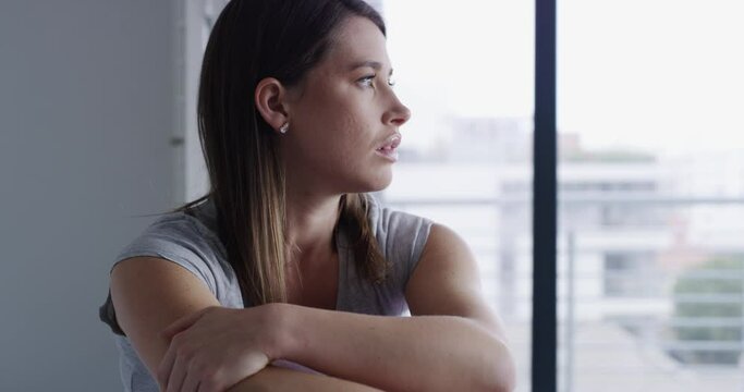 Phone, thinking or sad woman with depression in home with broken heart or bad news in message. Social media, window or frustrated female person reading with stress, anxiety or negative memory