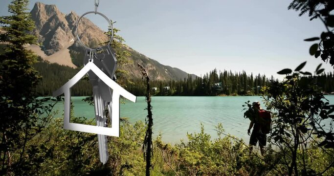 Animation of silver house and key over caucasian man at lake