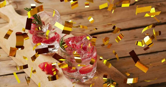 Animation of confetti falling over glasses of water with strawberries