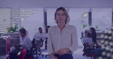Animation of data processing and world map over caucasian businesswoman with colleagues in office - Powered by Adobe