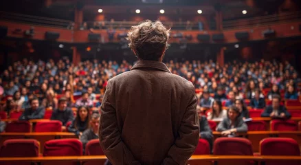 Foto op Plexiglas A solitary figure in a brown jacket stands amidst a sea of vibrant red, his eyes fixed upon the eager audience in the grand auditorium © Larisa AI