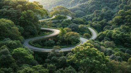 A winding road surrounded by lush green trees and hills.