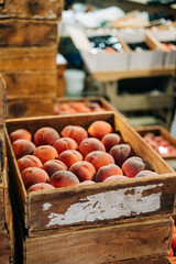 Ripe Bounty: Antique Wooden Crate Overflowing with Perfectly Ripened Peaches