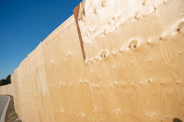wide angle view of plywood hoarding in the sun