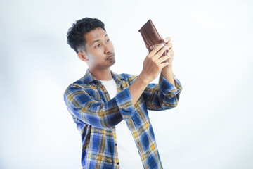 Adult Asian man showing his empty wallet with worried expression - obrazy, fototapety, plakaty