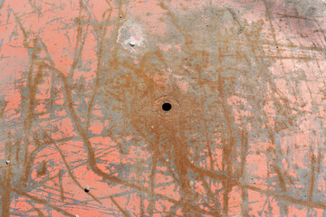 old steel plate with oxidization and a hole