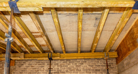 ceiling reinforcement with wood and supported by scaffolding