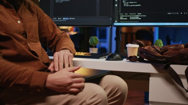 Remote programmer starting job shift in personal office at home, taking laptop out of bag. Teleworker unpacking backpack, writing lines of code on notebook keyboard, camera A close up
