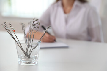 Set of different logopedic probes in holder on light table, space for text. Speech therapist's tools