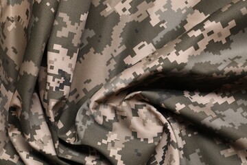 Texture of crumpled camouflage fabric as background, top view