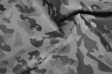 Texture of crumpled camouflage fabric as background, top view. Black and white effect