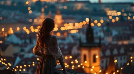 Foto op Canvas A graceful lady standing with a view of historic buildings in the city of Prague, Czech Republic in Europe. © Joyce