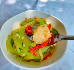 Selective focus. Sayur Labu Siam or Manisa or Jipang or Chayote. Indonesian food. Sayur Godog Labu Siem served in a bowl, isolated on white background. Top view.
