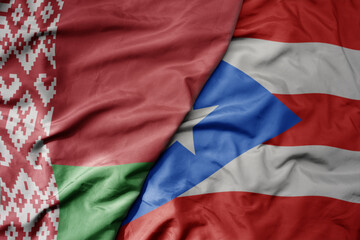 big waving national colorful flag of puerto rico and national flag of belarus.