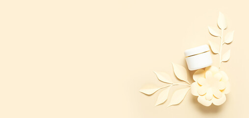 Natural cosmetic cream with paper decor on beige background with space for text