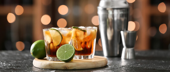 Glasses of tasty Cuba Libre cocktail on table