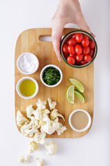 Roast cauliflower tomatoes and hummus salad