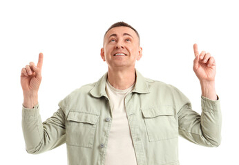 Naklejka premium Mature man pointing at something on white background