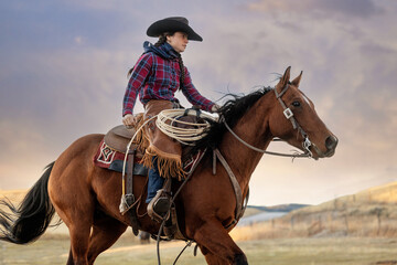 Cowgirl riding a horse galloping running western